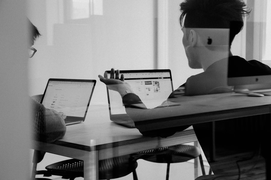 Team reviewing bids on a laptop